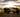 Pickup trucks lined up in a row, representing various brands with unique design features and characteristics, highlighting the diverse options available for truck enthusiasts on the website.
