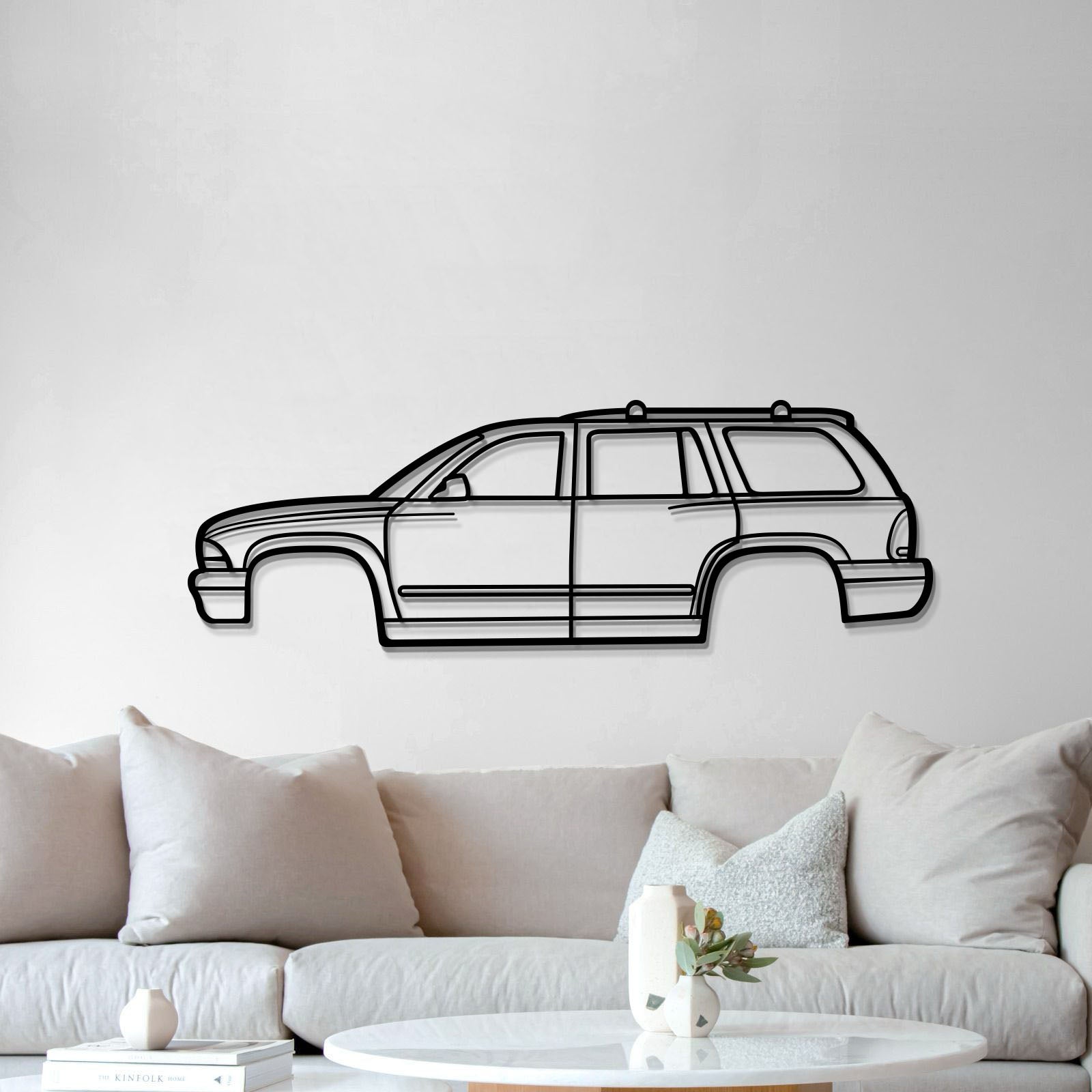 Durable 2002 Durango metal wall plaque in matte-textured steel, lifted 1 cm for a striking automotive display.